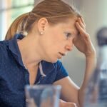 Businesswoman showing stress and concentration while working at her desk.